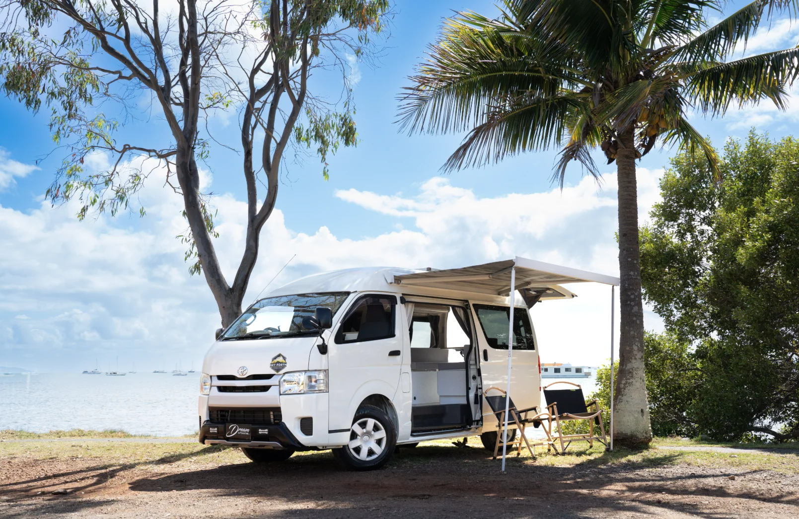 Campervan with awning extended beside the water